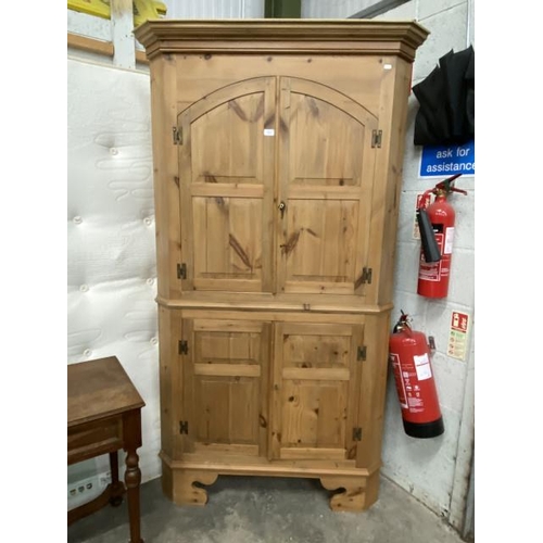 11 - Pine four door corner cupboard with shelves to the interior 200H 110W 61D