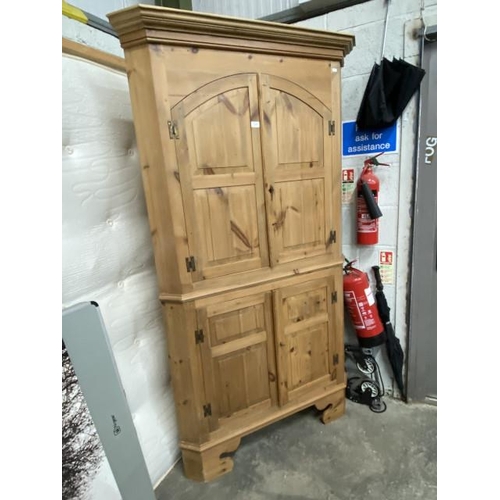 26 - Pine four door corner cupboard with shelves to the interior 200H 110W 61D