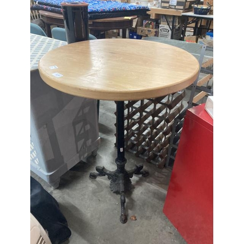 556 - Cast based bistro table with a pine circular top 84H 60cm diameter