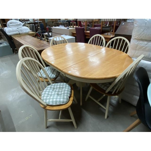 61 - Oak extending kitchen table 70H 106-150W 106D with six hoop back chairs