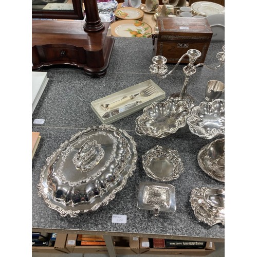 220 - Good collection of silver plate inc. candelabra, sauce boats, ladle, dishes, ice bucket, champagne b... 