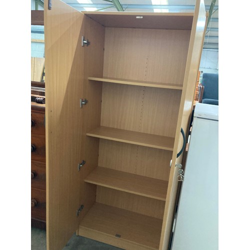 23 - Beech two door cupboard with shelves to the interior and two keys 181H 80W 40D