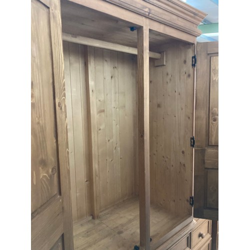 13 - Pine two door/four drawer wardrobe with hanging rail to the interior 210H 101W 57D