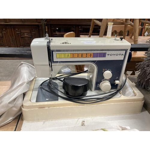 413 - Toyota model. 255 sewing machine with cover & foot pedal/mains lead