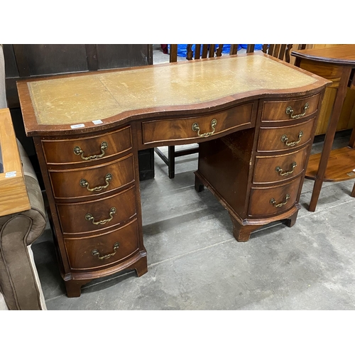 159 - Mahogany Serpentine 9 drawer desk with leather inset 75H 115W 53D