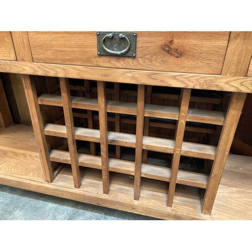 120 - Good quality oak sideboard with three drawers and wine rack 83H 181W 46D