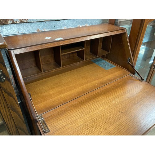 100 - Old Charm oak glazed cupboard 114H 54W 48D , oak effect bureau 107H 76W 37D and a mahogany effect gl... 