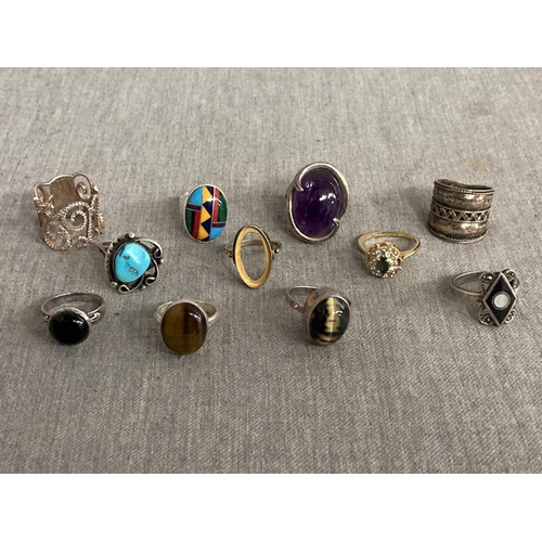 392 - 11 rings inc. silver, tigers eye, turquoise, jet etc.