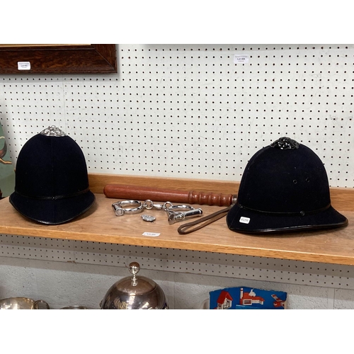 490 - Hiatt warranted wrought pair of Police handcuffs 1960's/70's, truncheon & 2 Police officer's hats