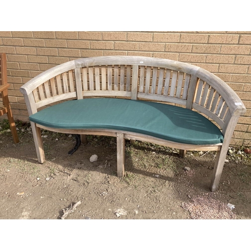 625 - Good quality teak curved garden bench with a seat pad 160cm wide