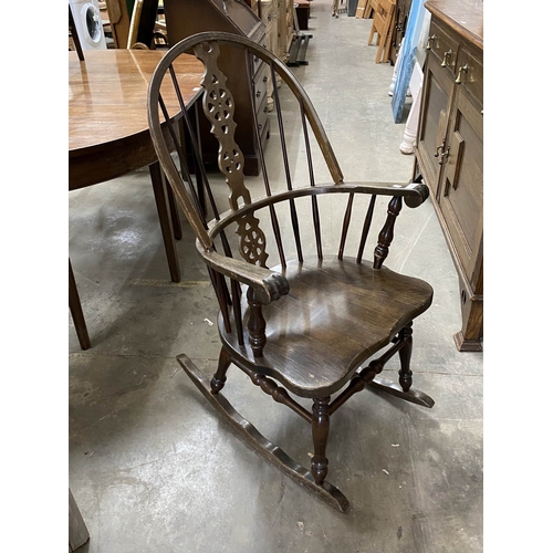 20 - Oak wheel back rocking chair 103H 61W 75D