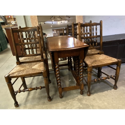 141 - Oak barley twist drop leaf table 73H 90W 45-120D & 4 spindle back chairs