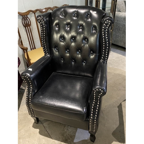 131 - Black faux leather button back Chesterfield wing armchair 112H x 75W