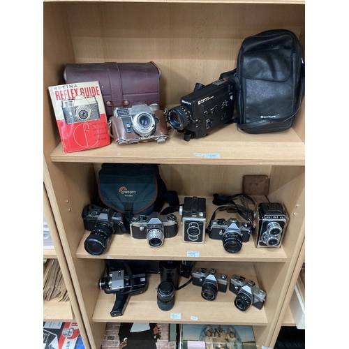 283 - Three shelves of vintage camera and video cameras including Kodak Retina Reflex III with guide, Sank... 