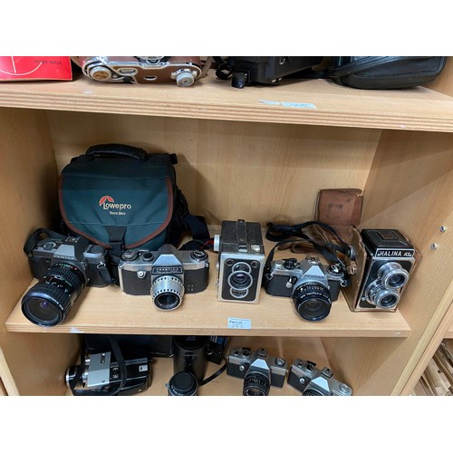 283 - Three shelves of vintage camera and video cameras including Kodak Retina Reflex III with guide, Sank... 