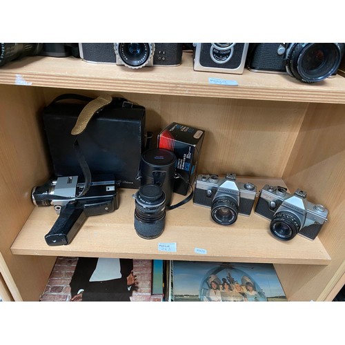 283 - Three shelves of vintage camera and video cameras including Kodak Retina Reflex III with guide, Sank... 