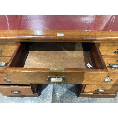 27 - Victorian mahogany pedestal campaign desk with brass handles and red leather inset 77H 122W 60D