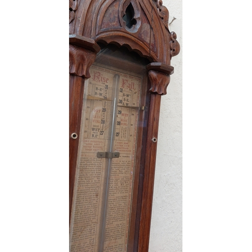 372 - Carved Oak Glass Front Rise and Fall Barometer by Chancellor & Son, Dublin.