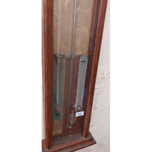 372 - Carved Oak Glass Front Rise and Fall Barometer by Chancellor & Son, Dublin.