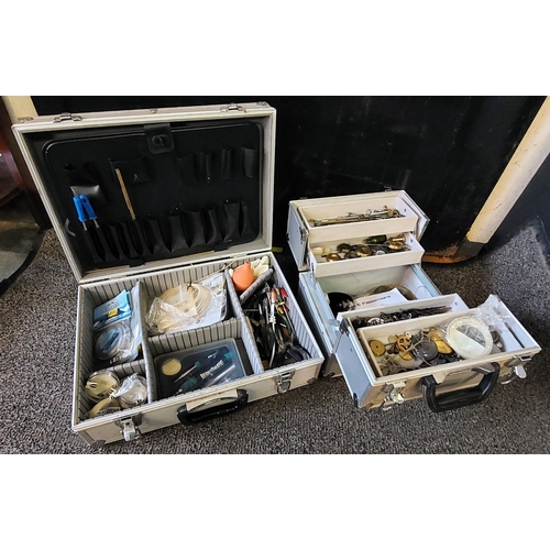 860 - 2 Silver Cases of Watchmakers Tools inc Soldering Iron, Nylon Wire, Spares etc