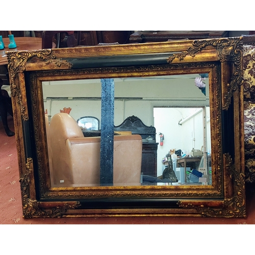 922A - Ornate Gilt and Ebonised Bevelled Overmantle Mirror - C. 124cm x 94cm