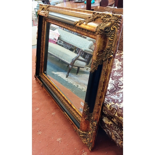 922A - Ornate Gilt and Ebonised Bevelled Overmantle Mirror - C. 124cm x 94cm