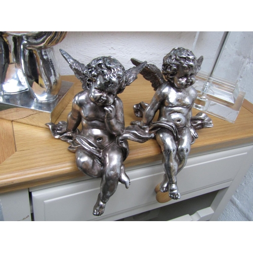 294 - Two Silver Plated Winged Cherubs Seated Form Each Approximately 10 Inches High