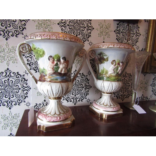 1600 - Pair of Capo Di Monte Porcelain Urns with Cherub Motif Decoration and Gilded Detailing Twin Handled ... 