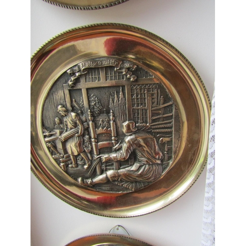 295 - Set of Four Heavy Brass Wall Chargers Depicting Trades People Each Approximately 13 Inches Diameter