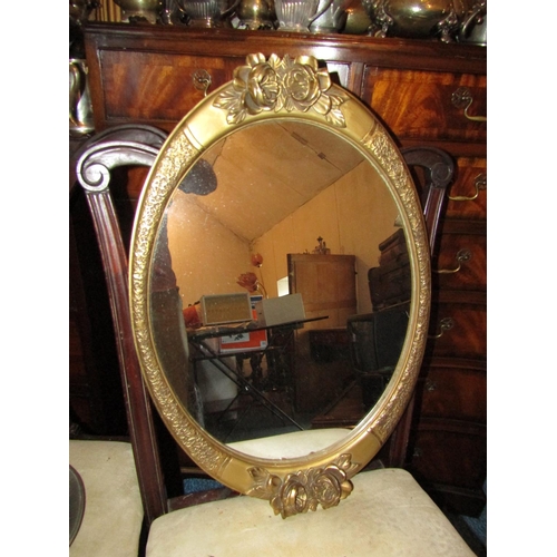 491 - Two Antique Oval Form Gilt Framed Wall Mirrors with Upper Floral Motif Decoration Approximately 26 I... 