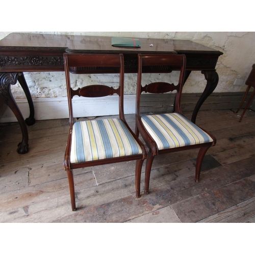 74 - Pair of Figured Mahogany Side Chairs with Well Carved Backs above Sabre Supports