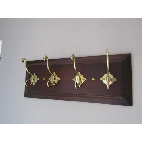 141 - Four Brass Hook Mahogany Panel Mounted Coat and Hat Hanger Approximately 20 Inches Wide