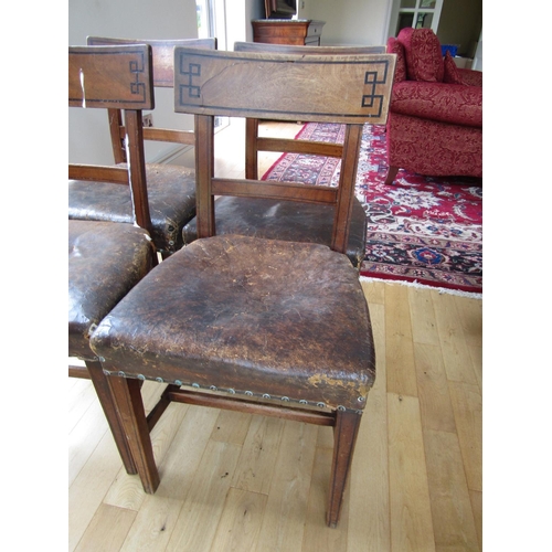 89 - Set of Four Irish Regency Leather Upholstered Chairs with Grecian Motif Ebony Inlaid Back Supports