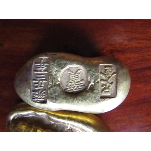 549 - Two Oriental Nuggets Possibly Currency Signed to Base with Characters Each Approximately 5cm Wide