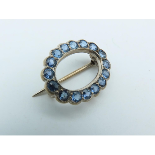 702 - Pale Blue Sapphire Brooch of Uniform Round Cut Vivid Light Blue Sapphires Mounted on 9 Carat Gold