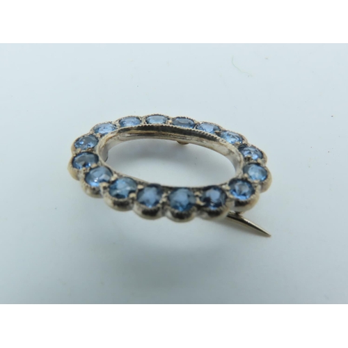 702 - Pale Blue Sapphire Brooch of Uniform Round Cut Vivid Light Blue Sapphires Mounted on 9 Carat Gold