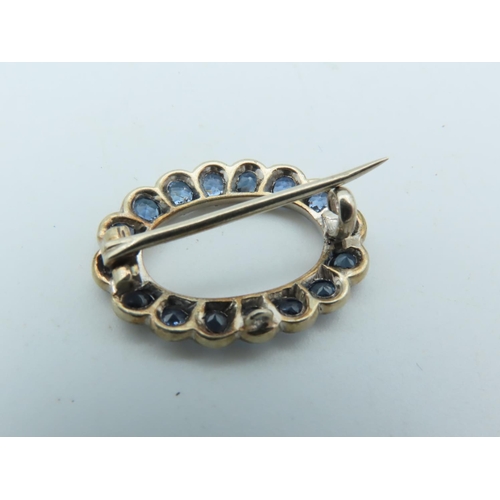 702 - Pale Blue Sapphire Brooch of Uniform Round Cut Vivid Light Blue Sapphires Mounted on 9 Carat Gold