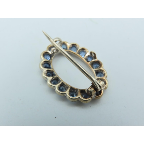 702 - Pale Blue Sapphire Brooch of Uniform Round Cut Vivid Light Blue Sapphires Mounted on 9 Carat Gold