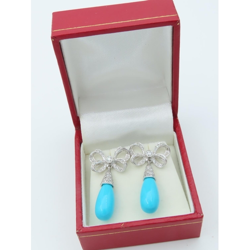 720 - Pair of Diamond and Turquoise Bow Motif Drop Earrings Each Post Headed by a Milligrane Collet Set Ro... 