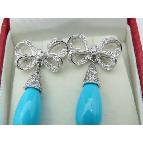 720 - Pair of Diamond and Turquoise Bow Motif Drop Earrings Each Post Headed by a Milligrane Collet Set Ro... 