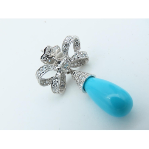 720 - Pair of Diamond and Turquoise Bow Motif Drop Earrings Each Post Headed by a Milligrane Collet Set Ro... 