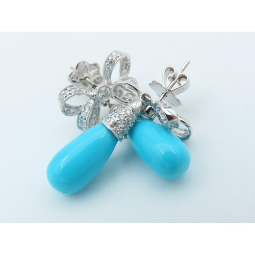 720 - Pair of Diamond and Turquoise Bow Motif Drop Earrings Each Post Headed by a Milligrane Collet Set Ro... 