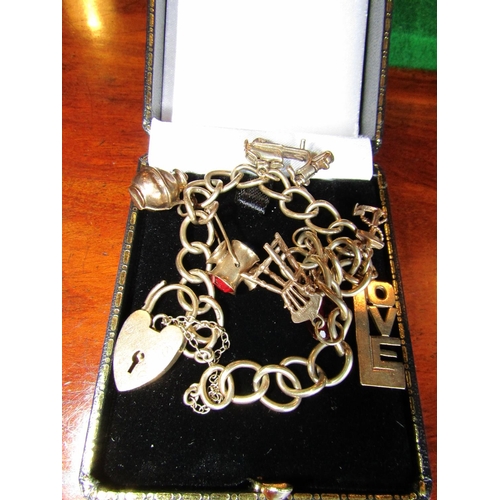 876 - 9 Carat Yellow Gold Charm Bracelet with Various Charms including Chair and Love Motifs