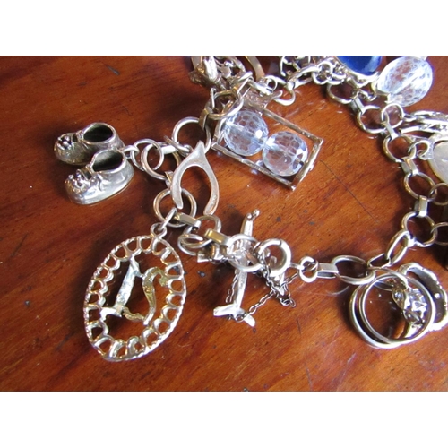 878 - 9 Carat Gold Charm Bracelet with 18 Various Charms