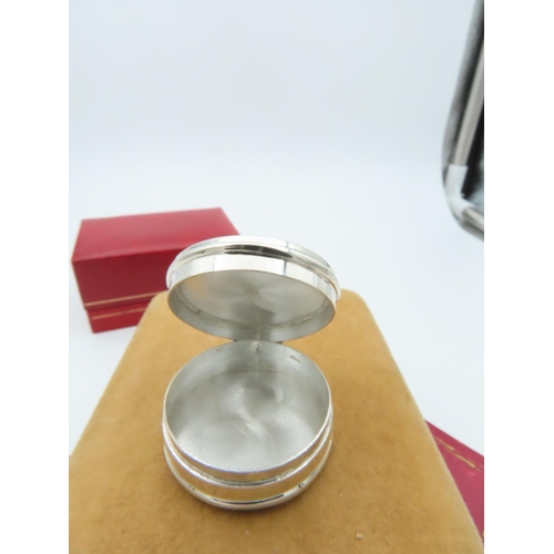 951 - Silver Circular Form Pill Box with Seated Figure to Top