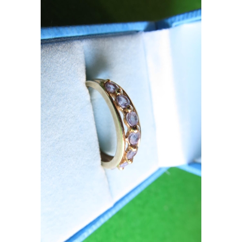 110 - 9 Carat Yellow Gold Half Eternity Ring Set with Seven Mauve Gemstones Size N and a Half