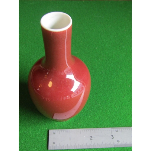 298 - Red Ground Slender Neck Oriental Vase Signed with Characters to Base Approximately 7 Inches High