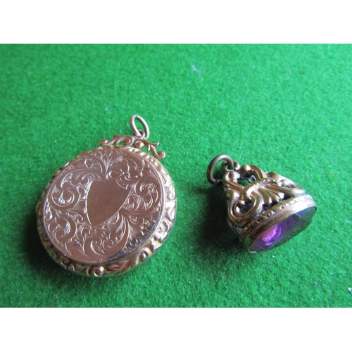 668 - Filled Gold Circular Form Locket Hinged Cover with Engraved Decoration and Amethyst Set Fob Seal