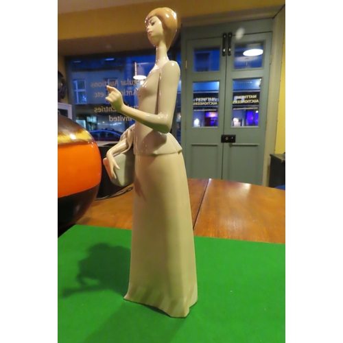 1057 - Lladro Fine Porcelain Figure of Lady with Parcel Approximately 11 Inches High Good Original Conditio... 