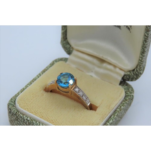 8 - 9 Carat Yellow Ladies Ring Set with Single Round Swiss Blue Topaz Centre Stone and Four Round Cut Di... 